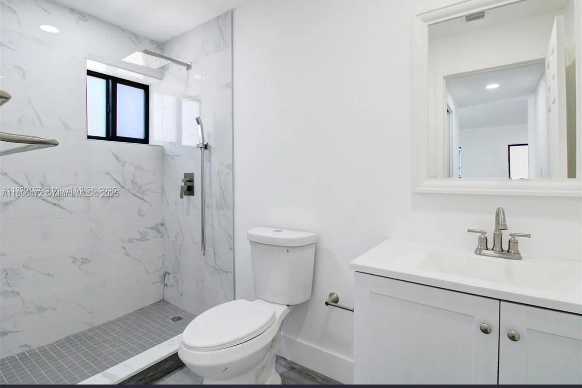 13885 Northwest 5th Avenue North Miami, FL 33168 - Photo 12 of 14 a white toilet sitting next to a bathroom sink