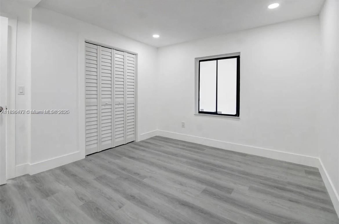 13885 Northwest 5th Avenue North Miami, FL 33168 - Photo 9 of 14 an empty room with wooden floor and windows
