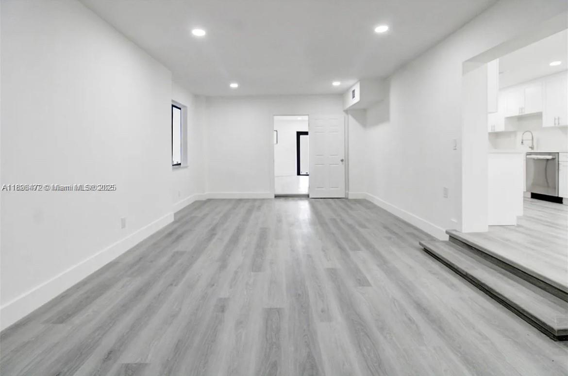13885 Northwest 5th Avenue North Miami, FL 33168 - Photo 10 of 14 an empty room with wooden floor and windows