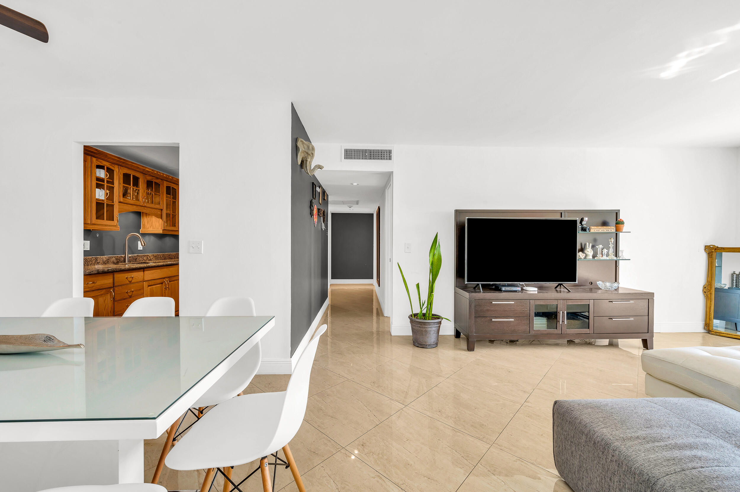 1111 South Ocean Boulevard, Unit 420 Boca Raton, FL 33432 - Photo 11 of 23 a living room with furniture and a flat screen tv