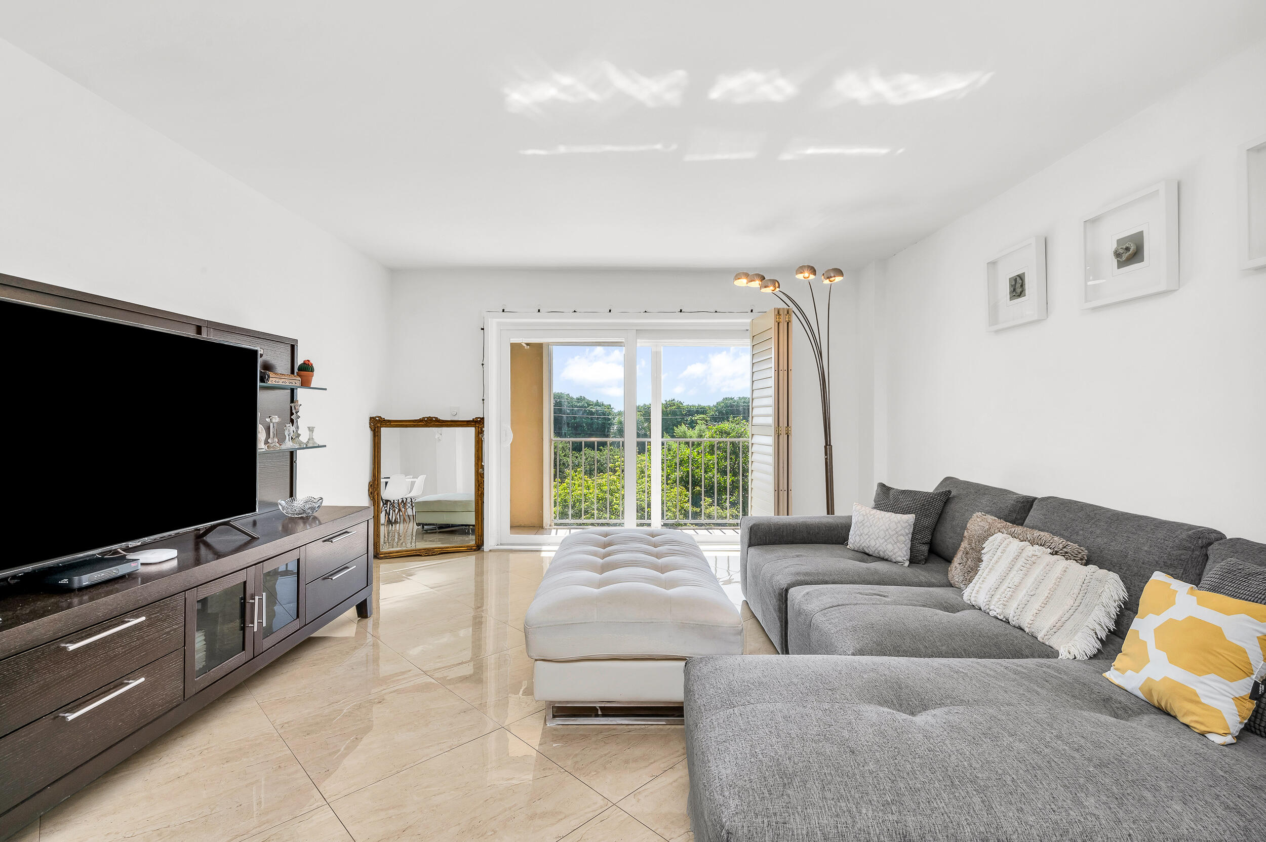 1111 South Ocean Boulevard, Unit 420 Boca Raton, FL 33432 - Photo 4 of 23 a living room with furniture and a flat screen tv