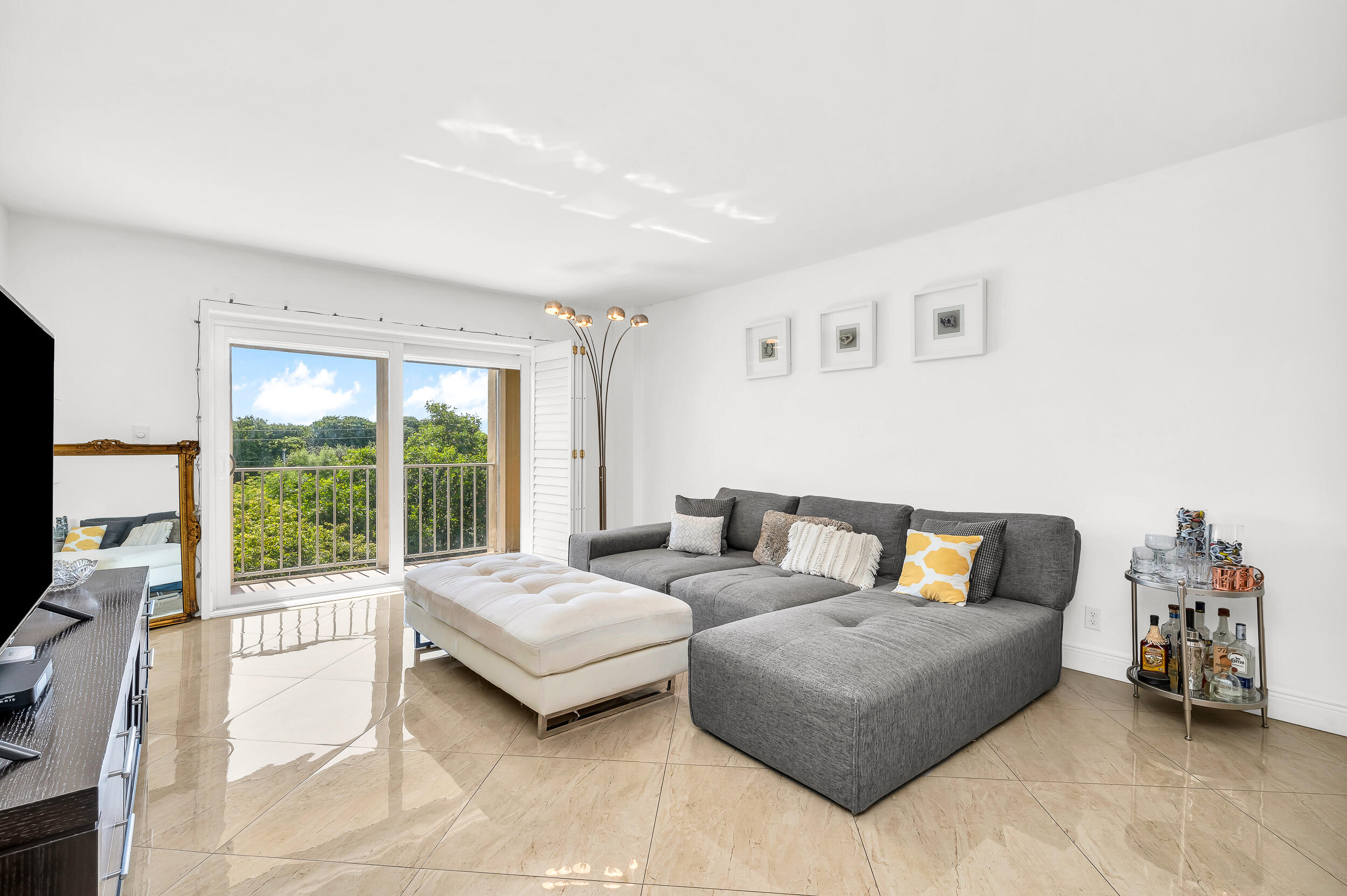1111 South Ocean Boulevard, Unit 420 Boca Raton, FL 33432 - Photo 5 of 23 a living room with furniture and a large window