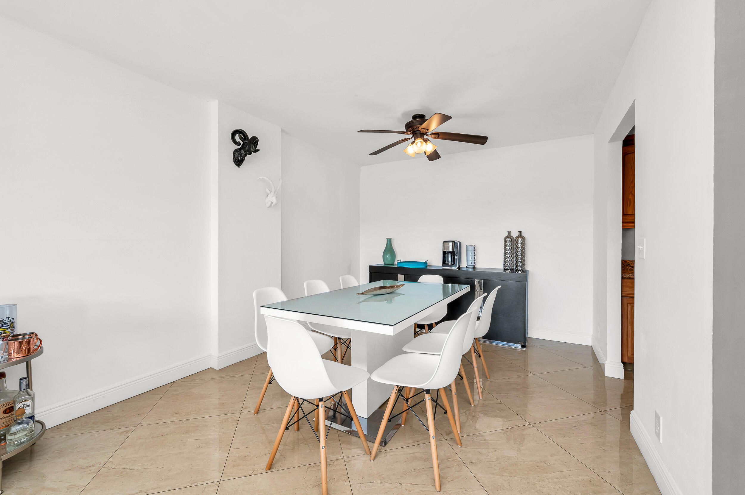1111 South Ocean Boulevard, Unit 420 Boca Raton, FL 33432 - Photo 8 of 23 a view of a dining room with furniture and a window