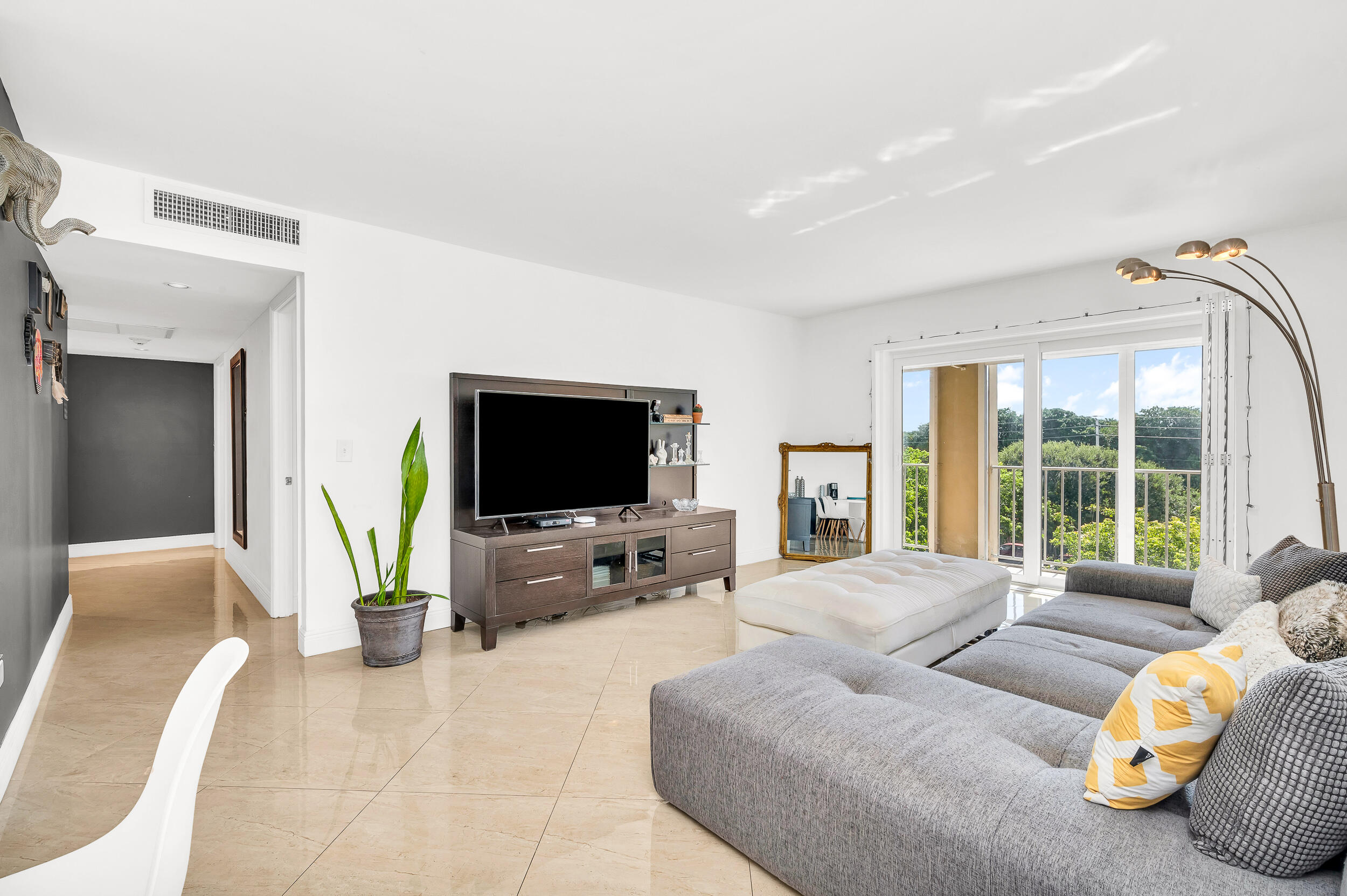 1111 South Ocean Boulevard, Unit 420 Boca Raton, FL 33432 - Photo 10 of 23 a living room with furniture and a flat screen tv