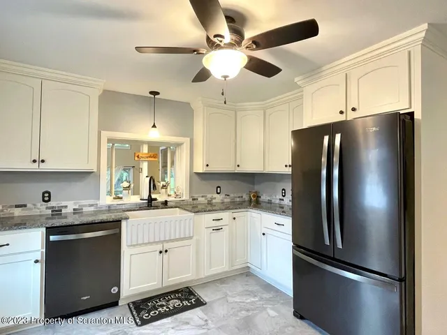 a aerial view of a house next to a yard