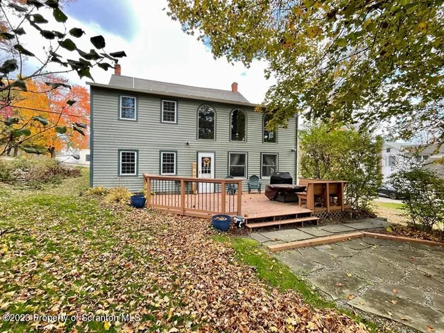 a view of a dining room with furniture a chandelier and wooden floor