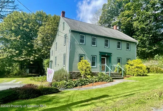 a view of a dining room with furniture and a chandelier