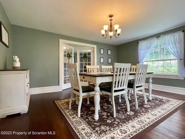 a bedroom with a bed dresser and a large window