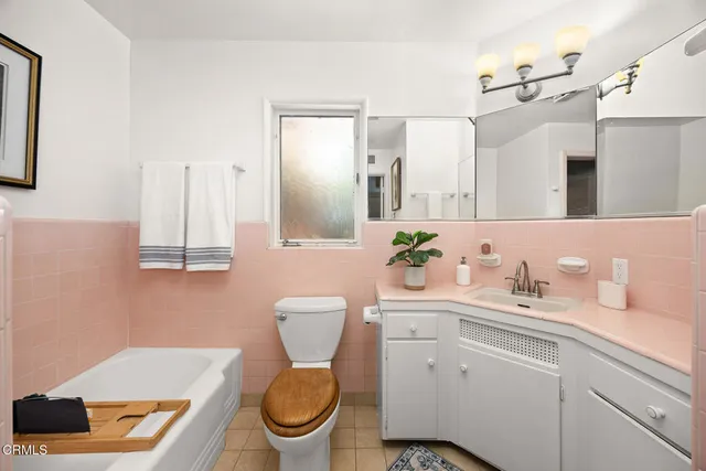 a view of a patio with table and chairs potted plants with wooden floor and fence