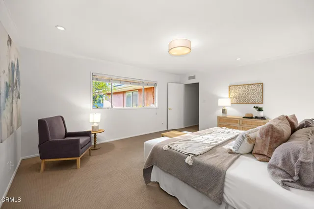a view of a house with a swimming pool and sitting area