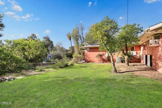 a view of a yard with a house in the background