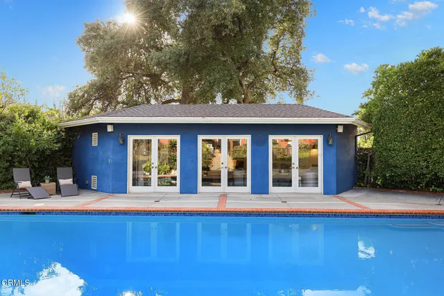 a view of a house with a yard and a car parked side of it