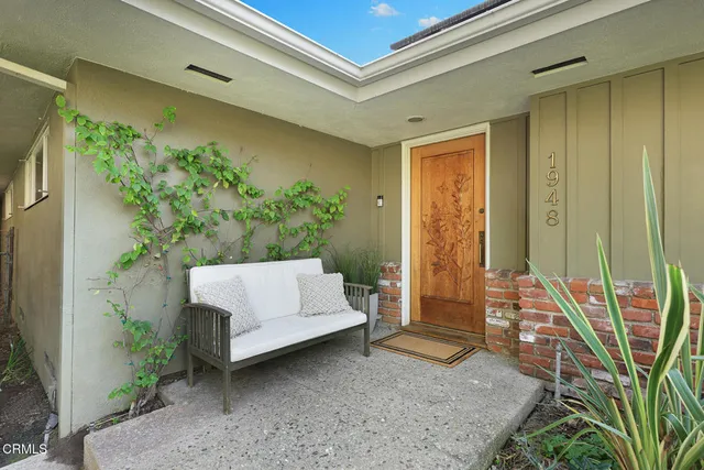 a living room with furniture large window and a fireplace