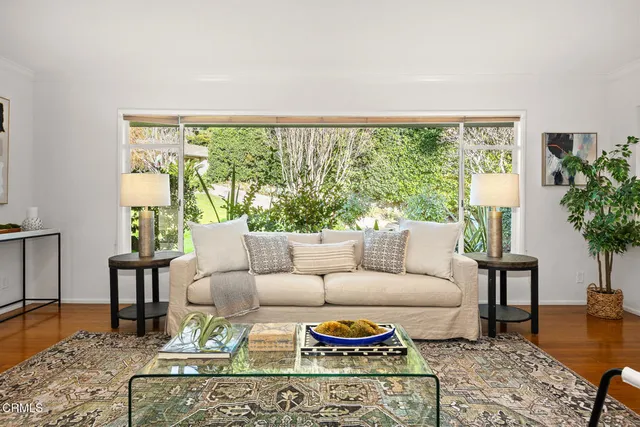 a living room with furniture and wooden floor