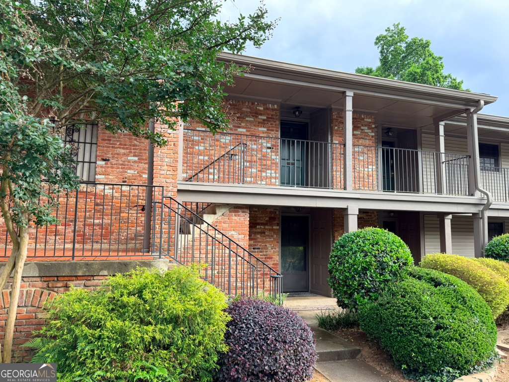 3097 Colonial Way, Unit M Chamblee, GA 30341 - Photo 2 of 11 a view of a house with a small yard and plants