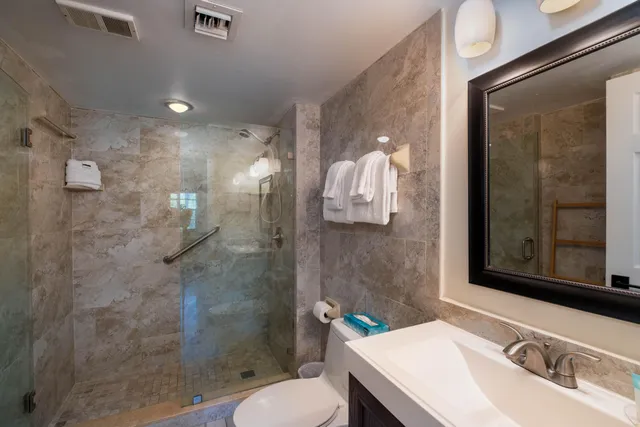 a bathroom with a sink toilet and shower