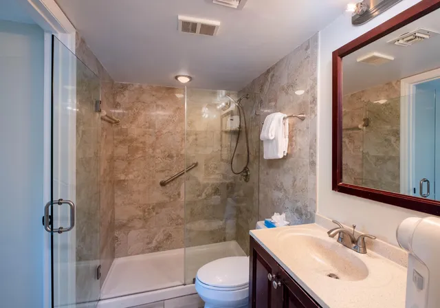 a bathroom with a sink toilet and shower