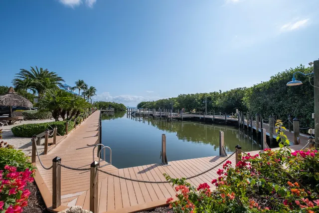 a view of a wooden floor and lake from a balcony
