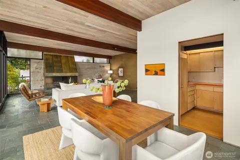 a backyard of a house with table and chairs