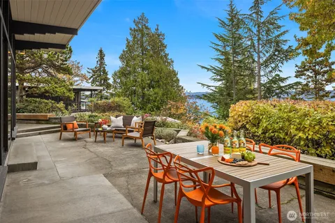 a kitchen with a stove a table and chairs in it
