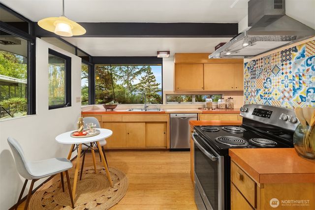 a bedroom with a large bed and wooden floor