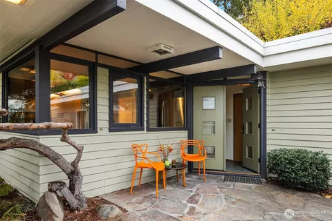 a front view of a house with outdoor seating