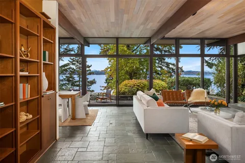 a outdoor space with the couches and dining table with the garden view
