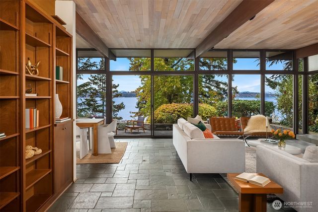 a outdoor space with the couches and dining table with the garden view