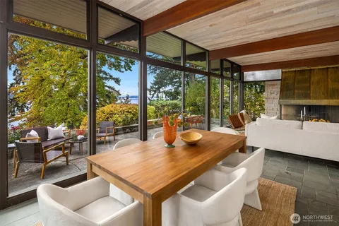 a view of a patio with table and chairs and potted plants