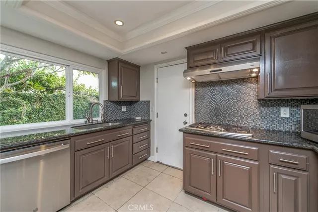 a kitchen with stainless steel appliances granite countertop a sink and cabinets