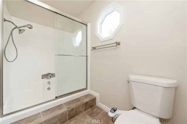 a bathroom with a shower and a toilet