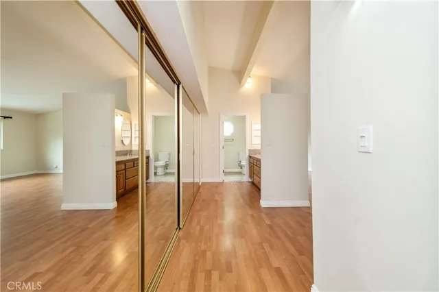 a view of a hallway with wooden floor