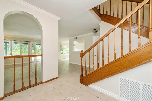 a view of staircase with railing and a window