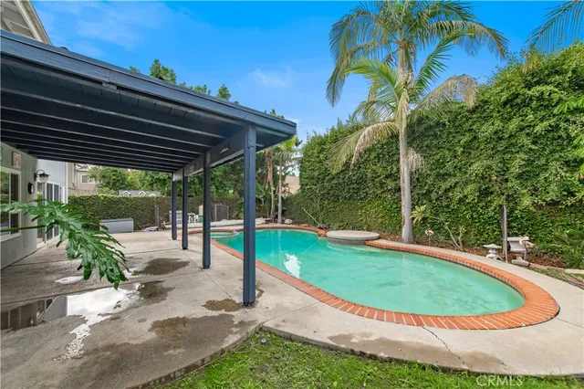 a view of a backyard with swimming pool