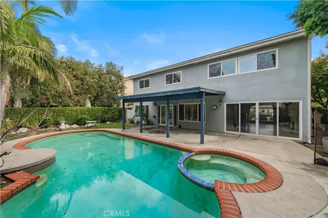 a view of a house with swimming pool and sitting area