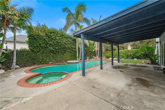 a view of a backyard with swimming pool