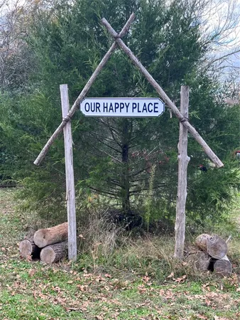 a backyard of a house with wooden fence and porch