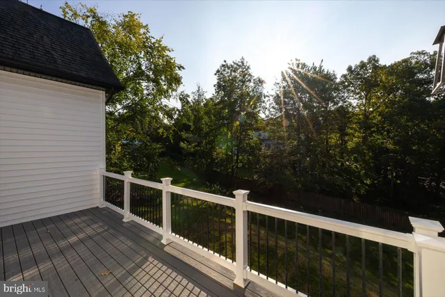 a view of empty room with wooden floor and a fireplace