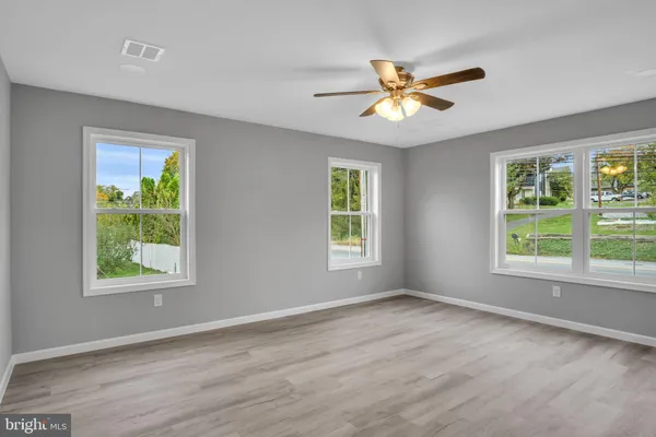 a view of a livingroom with a window and a ceiling fan