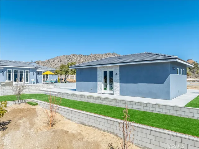 a view of a patio with a table and chairs