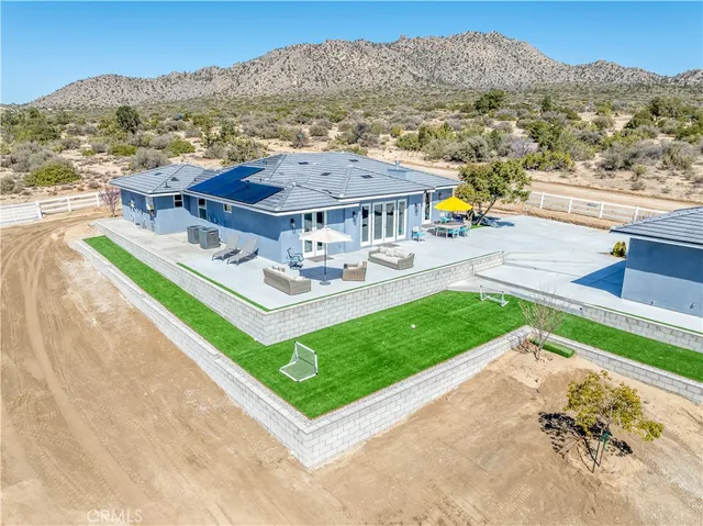 a view of a house with a yard and lake view