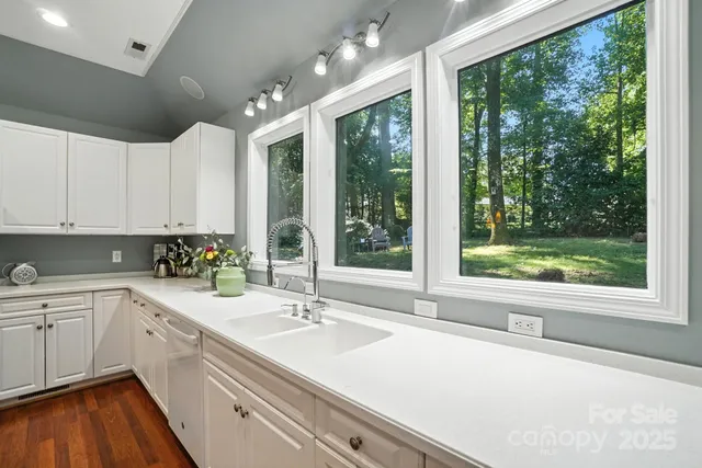 a kitchen with a sink and large window