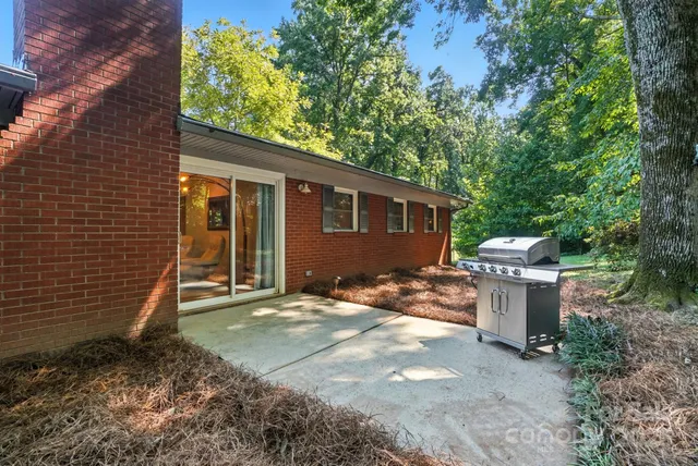 a backyard of a house with fountain and barbeque oven