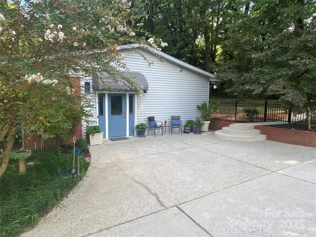 a backyard of a house with outdoor seating and green space