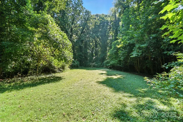 a backyard of a house with a yard and outdoor seating