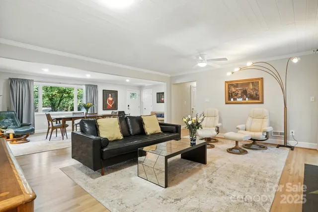 a living room with furniture and view of kitchen