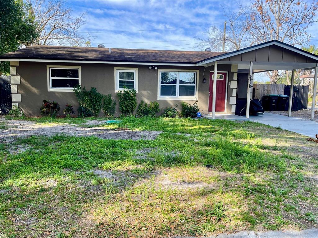 a view of a house with big yard and plants