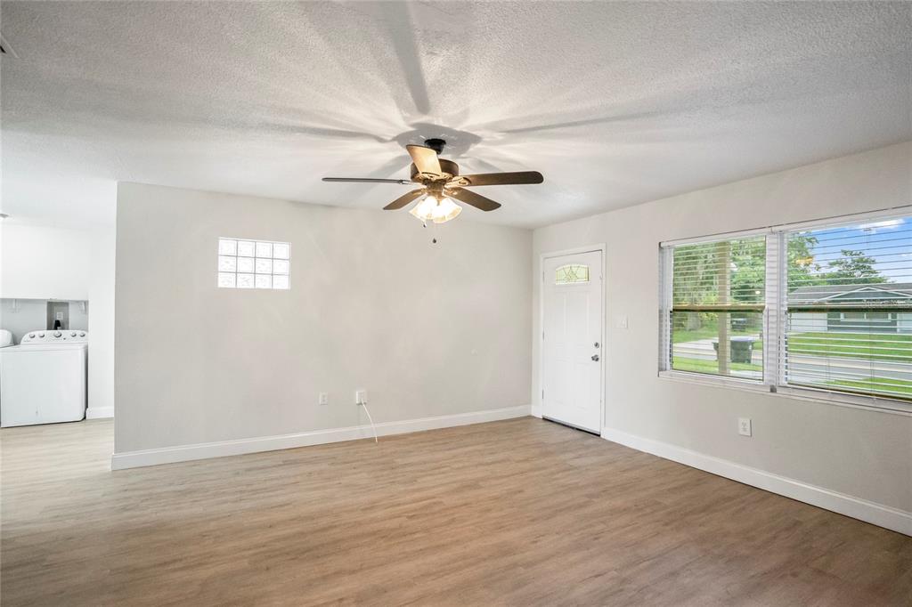 4138 Westgate Road Orlando, FL 32808 - Photo 11 of 29 wooden floor in an empty room with a window