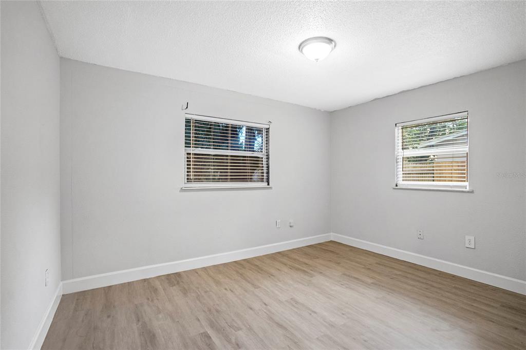 4138 Westgate Road Orlando, FL 32808 - Photo 16 of 29 a view of empty room with wooden floor and fan