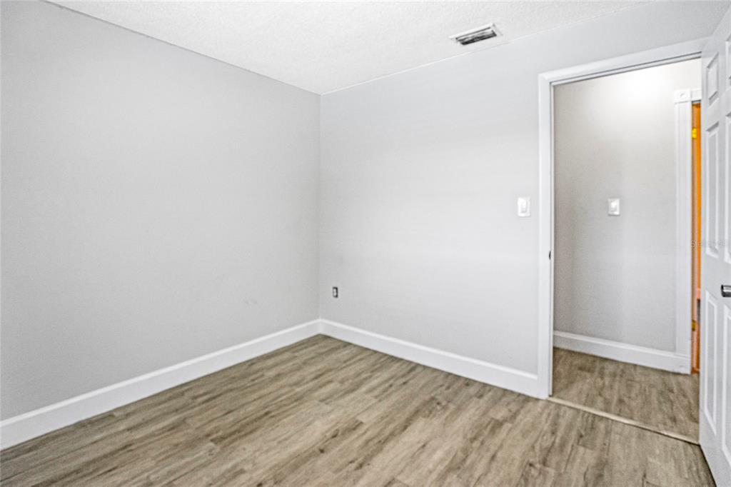 4138 Westgate Road Orlando, FL 32808 - Photo 20 of 29 wooden floor in an empty room